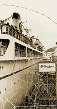 Load image into Gallery viewer, Black and white photograph of cruise steamship arriving at a dock. There are multiple streamers coming off the side of the ship and passengers waving from the decks. The image is orientated vertically.