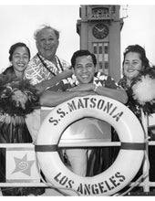 Load image into Gallery viewer, Black and white photograph of four people on a ship with a large life preserver in the foreground reading S.S. Matsonia Los Angeles. Aloha written on clock tower behind them.