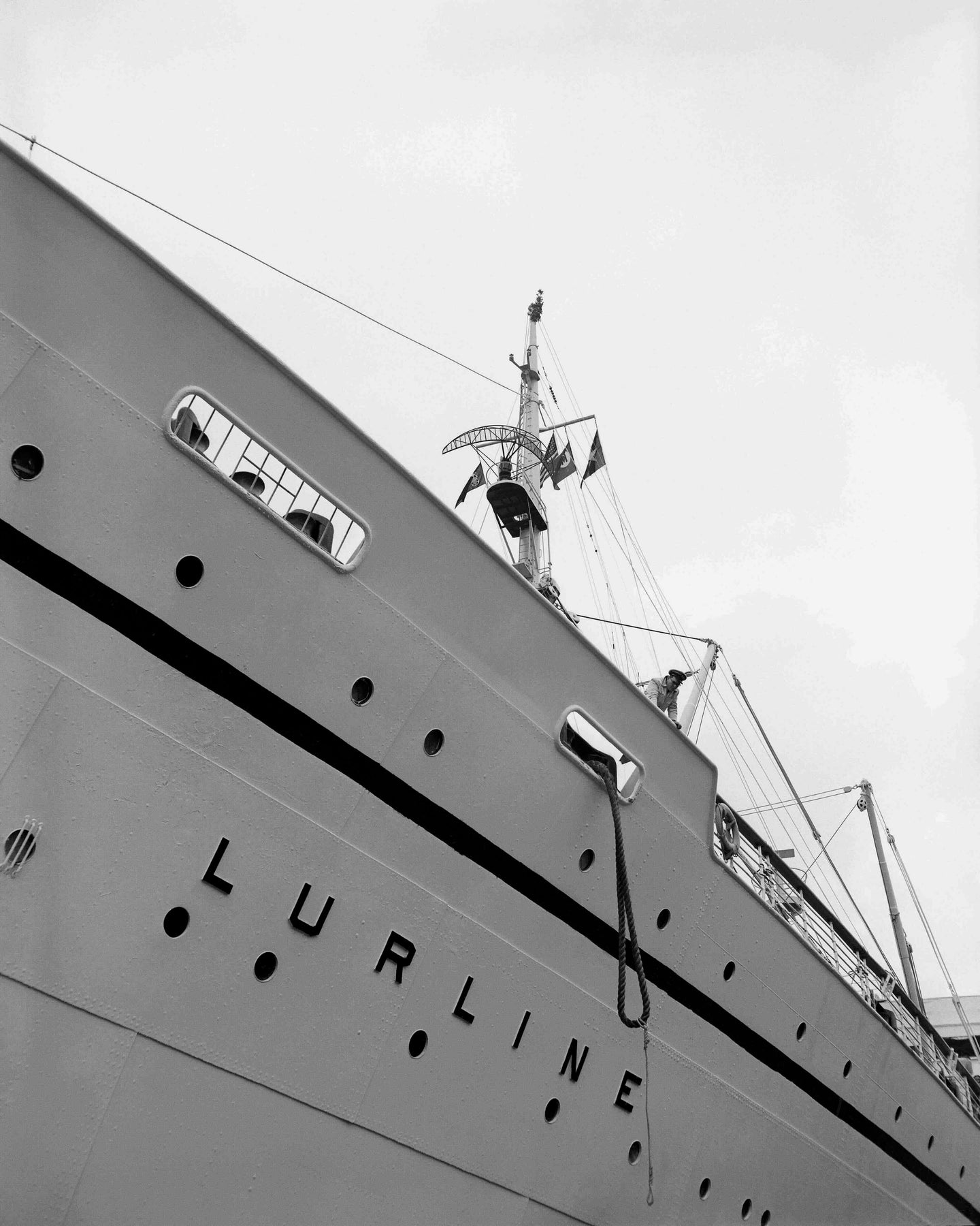 Black and white photo featuring a vertical shot of the S.S. Lurline's bow and name.